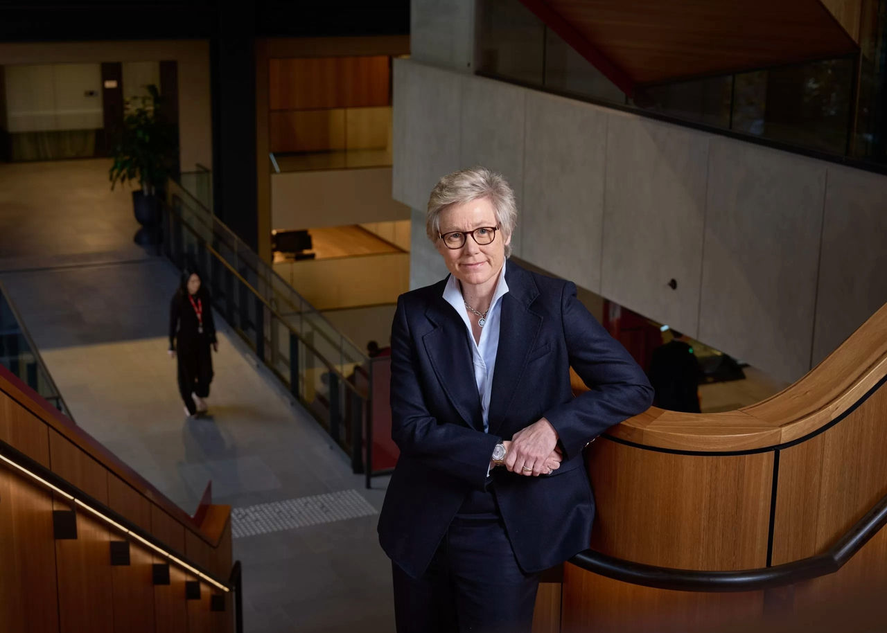woman with glasses standing on stairwell