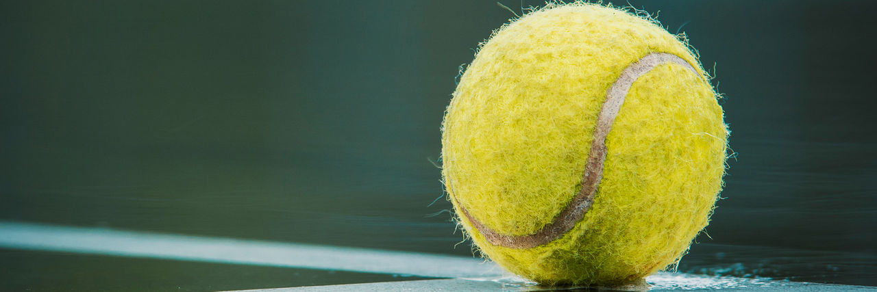 close up of tennis ball on tennis court